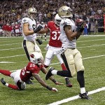 New Orleans Saints wide receiver Robert Meachem catches a touchdown pass in front of Arizona Cardinals cornerback Jerraud Powers (25) and strong safety Yeremiah Bell (37) in the first half of an NFL football game in New Orleans, Sunday, Sept. 22, 2013. (AP Photo/Bill Haber)
