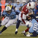 Arizona Cardinals quarterback Carson Palmer (3) is sacked for a 7-yard loss by Tennessee Titans defensive tackle Jurrell Casey (99) and Derrick Morgan (91) in the second quarter of an NFL football game Sunday, Dec. 15, 2013, in Nashville, Tenn. (AP Photo/Mark Zaleski)