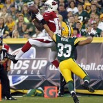 Arizona Cardinals' Jaron Brown catches a touchdown pass in front of Green Bay Packers' Micah Hyde (33) during the first half of a preseason NFL football game Friday, Aug. 9, 2013, in Green Bay, Wis. (AP Photo/Mike Roemer)