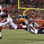 Arizona Cardinals wide receiver Jaron Brown (13) slips away from Denver Broncos defensive back Aaron Hester (40) on a 55-yard touchdown reception during the third quarter of a preseason NFL football game, Thursday, Aug. 29, 2013, in Denver. (AP Photo/Joe Mahoney)
