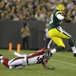 Green Bay Packers quarterback Vince Young scrambles away from Arizona Cardinals' Tony Jefferson during the second half of a preseason NFL football game Friday, Aug. 9, 2013, in Green Bay, Wis. (AP Photo/Tom Lynn)