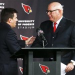 Arizona Cardinals president Michael Bidwill, left, shakes hands with new head coach Bruce Arians during an NFL football news conference at the team's training facility, Friday, Jan. 18, 2013, in Tempe, Ariz. The Cardinals bring in Arians after he had a storybook year as the Indianapolis Colts offensive coordinator-turned-temporary coach. He filled in for head coach Chuck Pagano while he was treated for cancer and helped get the Colts to the NFL playoffs.(AP Photo/Ross D. Franklin)
