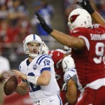 Indianapolis Colts quarterback Andrew Luck (12) throws under pressure from Arizona Cardinals outside linebacker Matt Shaughnessy (91) during the first half of an NFL football game, Sunday, Nov. 24, 2013, in Glendale, Ariz. (AP Photo/Rick Scuteri)