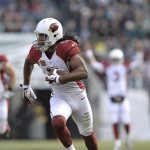 Arizona Cardinals' Larry Fitzgerald makes a 43-yard touchdown run during the first half of an NFL football game against the Philadelphia Eagles, Sunday, Dec. 1, 2013, in Philadelphia. (AP Photo/Michael Perez)