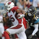 Arizona Cardinals wide receiver Michael Floyd (15) runs past Jacksonville Jaguars cornerback Will Blackmon (24) for a 91-yard touchdown in the second half of an NFL football game in Jacksonville, Fla., Sunday, Nov. 17, 2013. (AP Photo/Stephen Morton)