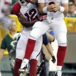 Arizona Cardinals' Carson Palmer and Andre Roberts (12) celebrate a touchdown reception during the first half of a preseason NFL football game against the Green Bay Packers Friday, Aug. 9, 2013, in Green Bay, Wis. (AP Photo/Mike Roemer)