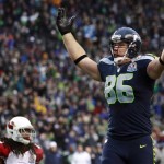 Seattle Seahawks tight end Zach Miller (86) celebrates in front of Arizona Cardinals strong safety Rashad Johnson (49) after scoring on a 24-yard touchdown reception during the second quarter of an NFL football game in Seattle, Sunday, Dec. 9, 2012. (AP Photo/Stephen Brashear)