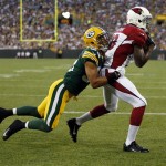 Arizona Cardinals' Jaron Brown catches a touchdown pass in front of Green Bay Packers' Micah Hyde during the first half of a preseason NFL football game Friday, Aug. 9, 2013, in Green Bay, Wis. (AP Photo/Tom Lynn)