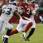 Arizona Cardinals quarterback Carson Palmer (3) scrambles under pressure from Seattle Seahawks outside linebacker Malcolm Smith (53) during the first half of an NFL football game, Thursday, Oct. 17, 2013, in Glendale, Ariz. (AP Photo/Ross D. Franklin)