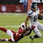 Arizona Cardinals cornerback Patrick Peterson (21) tackles Seattle Seahawks wide receiver Golden Tate (81) during the first half of an NFL football game, Thursday, Oct. 17, 2013, in Glendale, Ariz. (AP Photo/Ross D. Franklin)