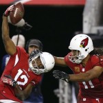Arizona Cardinals' Andre Roberts (12) celebrates his long pass reception against the Indianapolis Colts with teammate Larry Fitzgerald, right, during the second half of an NFL football game Sunday, Nov. 24, 2013, in Glendale, Ariz. The Cardinals defeated the Colts 40-11. (AP Photo/Ross D. Franklin)
