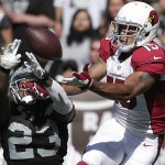 Arizona Cardinals wide receiver Michael Floyd (15) catches a touchdown pass over Oakland Raiders cornerback Tarell Brown (23) during the second quarter of an NFL football game in Oakland, Calif., Sunday, Oct. 19, 2014. (AP Photo/Marcio Jose Sanchez)