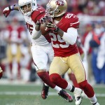 San Francisco 49ers defensive back Chris Culliver (29) runs from Arizona Cardinals wide receiver Michael Floyd (15) after intercepting the ball from quarterback Ryan Lindley during the third quarter of an NFL football game in Santa Clara, Calif., Sunday, Dec. 28, 2014. (AP Photo/Tony Avelar)
