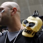 Oakland Raiders fan Chris DeRobertis, center, of Mahopac, N.Y., waits outside before the first round of the NFL football draft, Thursday, May 8, 2014, at Radio City Music Hall in New York. (AP Photo/Jason DeCrow)