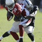 Arizona Cardinals running back Andre Ellington (38) is tackled by Oakland Raiders cornerback Keith McGill (39) during the third quarter of an NFL football game in Oakland, Calif., Sunday, Oct. 19, 2014. (AP Photo/Ben Margot)