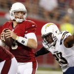 Arizona Cardinals quarterback Carson Palmer (3) looks to pass under pressure from San Diego Chargers outside linebacker Dwight Freeney during the first half of an NFL football game, Monday, Sept. 8, 2014, in Glendale, Ariz. (AP Photo/Ross D. Franklin)