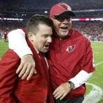 Arizona Cardinals head coach Bruce Arians, right, hugs Cardinals team president Michael Bidwill, left, as they celebrate after an NFL football game win over the Kansas City Chiefs Sunday, Dec. 7, 2014, in Glendale, Ariz. The Cardinals defeated the Chiefs 17-14. (AP Photo/Ross D. Franklin)