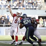 Arizona Cardinals quarterback Drew Stanton (5) passes as Cardinals' Lyle Sendlein, right, blocks Seattle Seahawks Bobby Wagner (54) in the first half of an NFL football game, Sunday, Nov. 23, 2014, in Seattle. (AP Photo/Elaine Thompson)