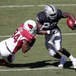 Oakland Raiders running back Darren McFadden (20) is tackled by Arizona Cardinals outside linebacker Sam Acho (94) during the first quarter of an NFL football game in Oakland, Calif., Sunday, Oct. 19, 2014. (AP Photo/Marcio Jose Sanchez)