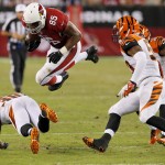 Arizona Cardinals tight end Darren Fells (85) is hit by Cincinnati Bengals strong safety Shawn Williams, bottom, during the second half of an NFL preseason football game, Sunday, Aug. 24, 2014, in Glendale, Ariz. (AP Photo/Ross D. Franklin)