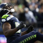 Seattle Seahawks defensive end Cliff Avril reacts after he sacked Arizona Cardinals quarterback Drew Stanton in the first half of an NFL football game, Sunday, Nov. 23, 2014, in Seattle. (AP Photo/Elaine Thompson)