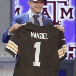 
Texas A&M quarterback Johnny Manziel holds up a Cleveland Browns jersey after being selected as the 22nd pick in the first round of the 2014 NFL Draft, Thursday, May 8, 2014, in New York. (AP Photo/Frank Franklin II)