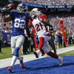 New York Giants wide receiver Rueben Randle (82) catches a pass for a touchdown in front of Arizona Cardinals' Patrick Peterson (21) during the first half of an NFL football game Sunday, Sept. 14, 2014, in East Rutherford, N.J. (AP Photo/Kathy Willens)