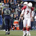 Arizona Cardinals kicker Chandler Catanzaro (7) reacts after missing a field goal as he stands in front to holder Drew Butler and near Seattle Seahawks outside linebacker Malcolm Smith (53) who walks off the field in the first half of an NFL football game, Sunday, Nov. 23, 2014, in Seattle. (AP Photo/Stephen Brashear)