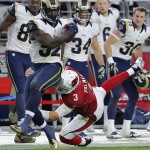 Arizona Cardinals quarterback Carson Palmer (3) saves a touchdown as he makes the tackle after throwing an interception to St. Louis Rams outside linebacker Alec Ogletree (52) during the second half of an NFL football game, Sunday, Nov. 9, 2014, in Glendale, Ariz. (AP Photo/Rick Scuteri)