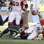 Arizona Cardinals quarterback Drew Stanton (5) is sacked by Seattle Seahawks' Jordan Hill, left, in the first half of an NFL football game, Sunday, Nov. 23, 2014, in Seattle. (AP Photo/Elaine Thompson)