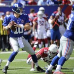 New York Giants quarterback Eli Manning (10) looks to pass as Arizona Cardinals defensive end Calais Campbell (93) rushes the passer during the first half of an NFL football game Sunday, Sept. 14, 2014, in East Rutherford, N.J. (AP Photo/Bill Kostroun)