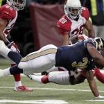 St. Louis Rams running back Benny Cunningham (36) is tackled by Arizona Cardinals cornerback Jerraud Powers during the first half of an NFL football game Thursday, Dec. 11, 2014 in St. Louis. (AP Photo/Tom Gannam)