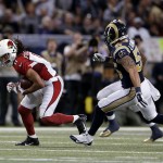 Arizona Cardinals' Larry Fitzgerald (11) is chased by St. Louis Rams' James Laurinaitis (55) following a catch during the first half of an NFL football game Thursday, Dec. 11, 2014 in St. Louis. (AP Photo/Jeff Roberson)