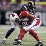 Arizona Cardinals' Larry Fitzgerald (11) is tackled by St. Louis Rams' E.J. Gaines during the first half of an NFL football game Thursday, Dec. 11, 2014 in St. Louis. (AP Photo/Jeff Roberson)