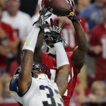 Arizona Cardinals wide receiver John Brown, rear, pulls in a pass over St. Louis Rams cornerback E.J. Gaines (33) during the first half of an NFL football game, Sunday, Nov. 9, 2014, in Glendale, Ariz. (AP Photo/Rick Scuteri)