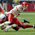 Kansas City Chiefs quarterback Alex Smith (11) is hit by Arizona Cardinals defensive end Calais Campbell (93) during the first half of an NFL football game, Sunday, Dec. 7, 2014, in Glendale, Ariz. (AP Photo/Rick Scuteri)