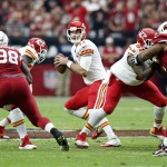 Kansas City Chiefs quarterback Alex Smith (11) drops back to pass against the Arizona Cardinals during the first half of an NFL football game, Sunday, Dec. 7, 2014, in Glendale, Ariz. (AP Photo/Ross D. Franklin)