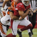  Arizona Cardinals wide receiver Larry Fitzgerald (11) pulls in a pass as Cincinnati Bengals cornerback Leon Hall makes the tackle during the first half of an NFL preseason football game, Sunday, Aug. 24, 2014, in Glendale, Ariz. (AP Photo/Matt York)