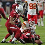 Kansas City Chiefs tight end Travis Kelce fumbles the ball as Arizona Cardinals cornerback Justin Bethel (28) defends during the second half of an NFL football game, Sunday, Dec. 7, 2014, in Glendale, Ariz. The Cardinals recovered the ball and went on to win 17-14 to improve to 10-3. (AP Photo/Rick Scuteri)