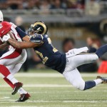 Arizona Cardinals wide receiver John Brown escapes a tackle attempt by St. Louis Rams cornerback Trumaine Johnson as he gains 14 yards in the fourth quarter of an NFL football game, Thursday, Dec. 11, 2014 in St. Louis. Arizona won 12-6. (AP Photo/St. Louis Post-Dispatch, Chris Lee)