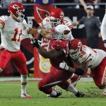 Kansas City Chiefs quarterback Alex Smith (11) is pressured by Arizona Cardinals nose tackle Dan Williams (92) during the second half of an NFL football game, Sunday, Dec. 7, 2014, in Glendale, Ariz. (AP Photo/Rick Scuteri)