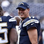 San Diego Chargers quarterback Philip Rivers talks with tight end Antonio Gates, left, during warmup before facing the Arizona Cardinals in an NFL preseason football game Thursday, Aug. 28, 2014, in San Diego. (AP Photo/Denis Poroy)