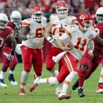 Kansas City Chiefs quarterback Alex Smith (11) is chased up field b the Arizona Cardinals during the first half of an NFL football game, Sunday, Dec. 7, 2014, in Glendale, Ariz. (AP Photo/Rick Scuteri)