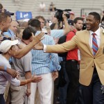 Hall of Fame Inductee Michael Strahan greets fans during the 2014 Pro Football Hall of Fame Enshrinement Ceremony at the Pro Football Hall of Fame Saturday, Aug. 2, 2014, in Canton, Ohio. (AP Photo/Tony Dejak)