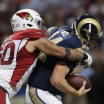 St. Louis Rams quarterback Shaun Hill (14) is sacked by Arizona Cardinals' Larry Foote (50) during the second half of an NFL football game Thursday, Dec. 11, 2014 in St. Louis. (AP Photo/Jeff Roberson)