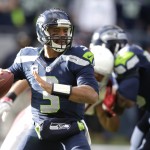 Seattle Seahawks quarterback Russell Wilson looks to pass in the first half of an NFL football game against the Arizona Cardinals, Sunday, Nov. 23, 2014, in Seattle. (AP Photo/Stephen Brashear)