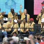 Former Buffalo Bills quarterback Jim Kelly waves to the crowd during the 2014 Pro Football Hall of Fame Enshrinement Ceremony at the Pro Football Hall of Fame Saturday, Aug 2, 2014 in Canton, Ohio. (AP Photo/David Richard)