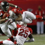Atlanta Falcons running back Devonta Freeman (24) is hit by Arizona Cardinals strong safety Deone Bucannon (36) during the first half of an NFL football game, Sunday, Nov. 30, 2014, in Atlanta. (AP Photo/Brynn Anderson )