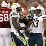 San Diego Chargers outside linebacker Dwight Freeney (93) celebrates a stop against the Arizona Cardinals with teammate Jeremiah Attaochu (97) during the second half of an NFL football game, Monday, Sept. 8, 2014, in Glendale, Ariz. (AP Photo/Ross D. Franklin)
