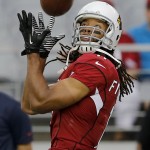 Arizona Cardinals wide receiver Larry Fitzgerald (11) makes a catch prior to an NFL preseason football game against the Houston Texans, Saturday, Aug. 9, 2014, in Glendale, Ariz. (AP Photo/Rick Scuteri)